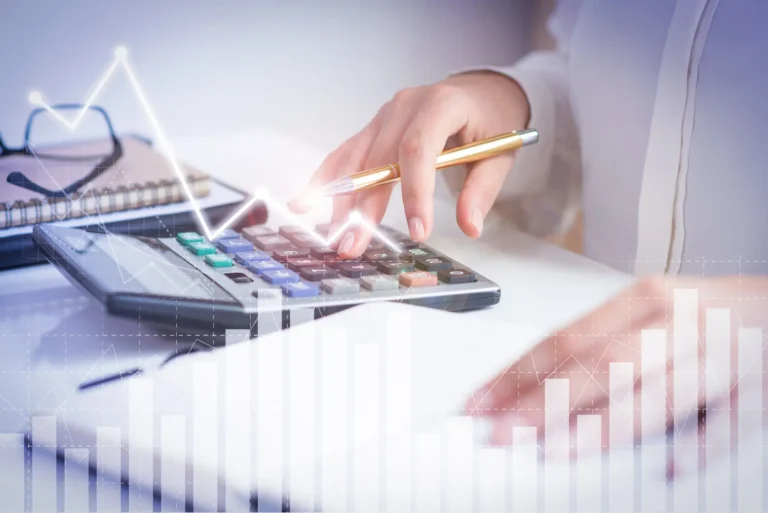 Person using calculator to plan 2026 tax brackets with IRS updates and higher standard deductions