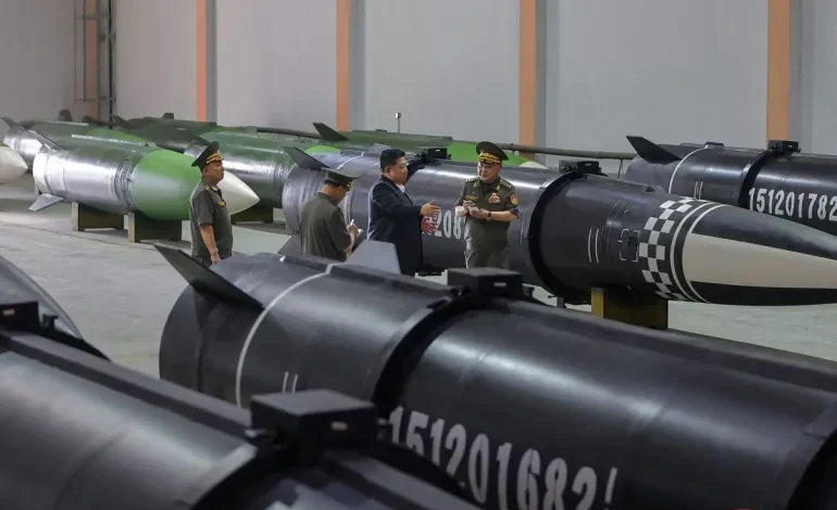 Kim Jong Un inspecting missile production at a secret facility, surrounded by engineers and machinery.