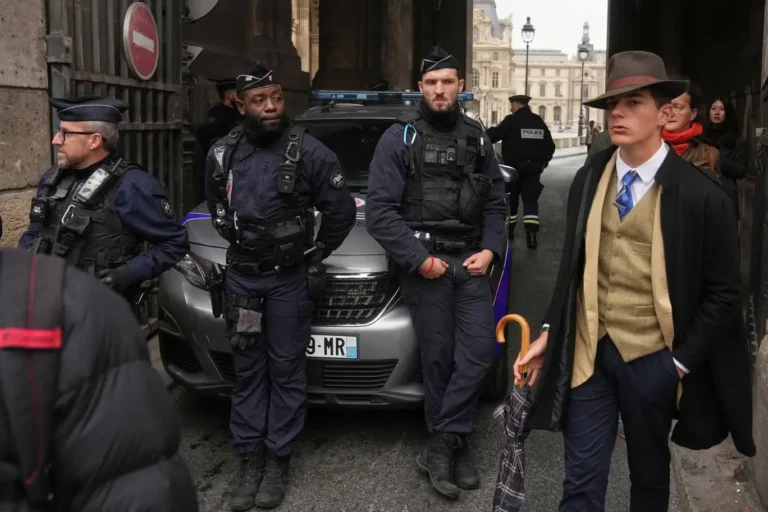Masked gang members in black clothing running through the Louvre courtyard during a daylight jewel robbery, carrying stolen cases of priceless jewelry.