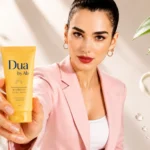 Dua Lipa promoting Dua by AB hydrating sunscreen skincare cream in a premium beauty campaign with natural glow makeup and soft aesthetic background