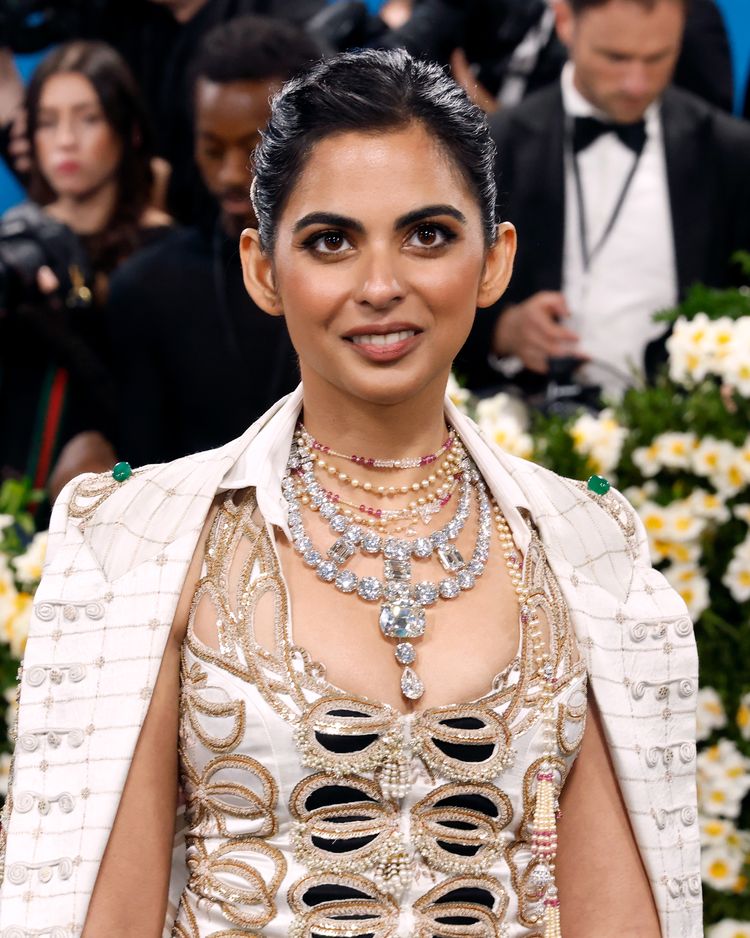 Isha Ambani wearing a white embellished couture outfit and layered diamond necklaces at the 2025 Met Gala