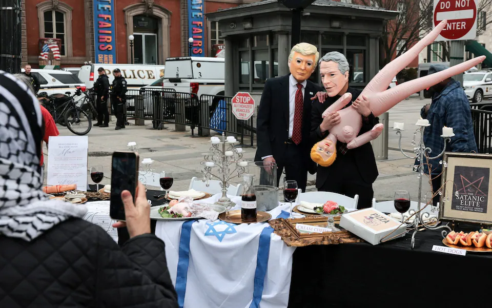Protesters wearing Donald Trump and Jeffrey Epstein masks during a demonstration near White House