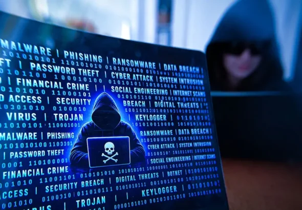 Hooded hacker using a laptop with a skull and crossbones icon, surrounded by malware and cyberattack terms - illustrating how famous hackers got caught